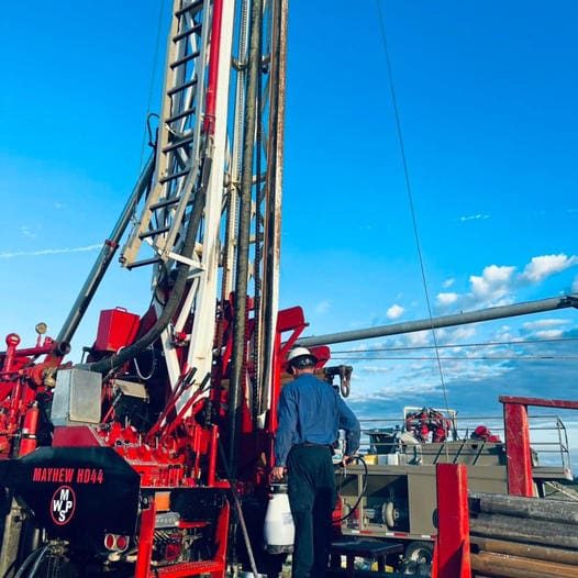 Mobley drill rig against a blue sky